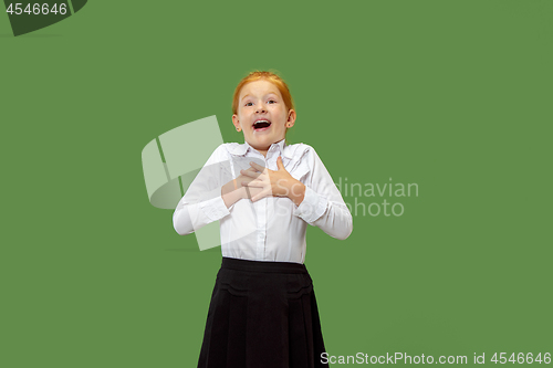 Image of Beautiful teen girl looking suprised isolated on green