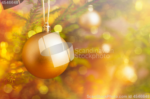 Image of Christmas-tree decoration bauble on decorated Christmas tree bac