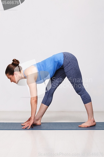 Image of Woman doing Ashtanga Vinyasa yoga asana Parsvottanasana