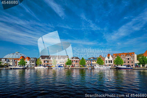 Image of Boats and houses on Spaarne river. Haarlem, Netherlands