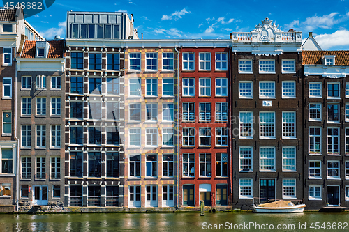 Image of  houses and boat on Amsterdam canal  Damrak with reflection. Ams