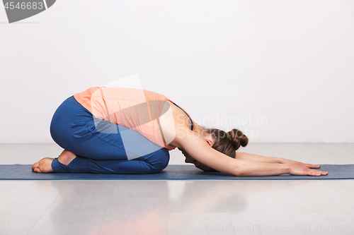 Image of Woman relax in Hatha yoga asana Balasana child pose