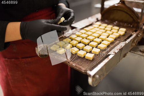 Image of confectioner with chocolate coating machine