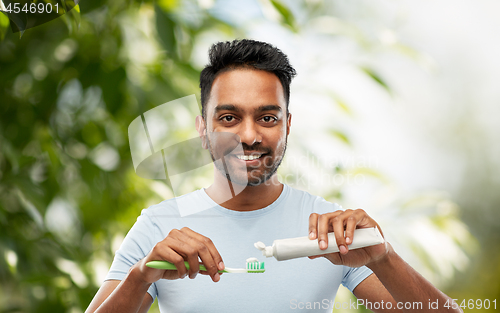 Image of indian man with toothbrush and toothpaste