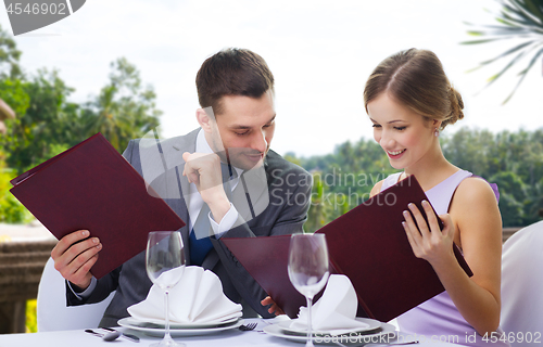 Image of couple with menus at restaurant