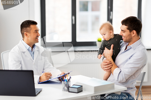 Image of father with baby and doctor at clinic