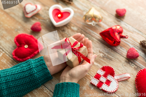 Image of close up of hands holding christmas gift