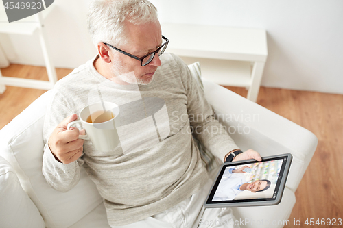 Image of senior man having video chat with pharmacist