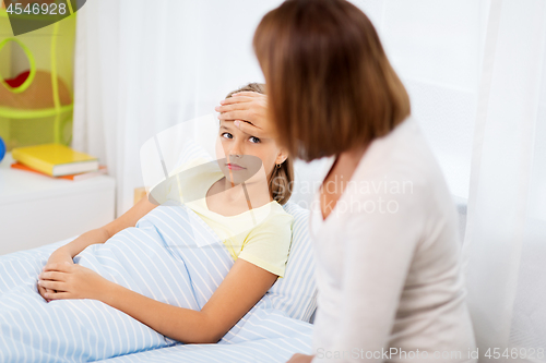 Image of mother taking care of unhealthy daughter at home