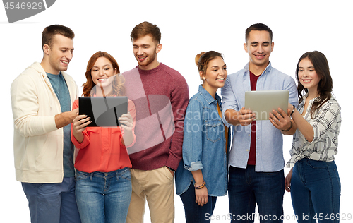 Image of group of smiling friends with tablet computers