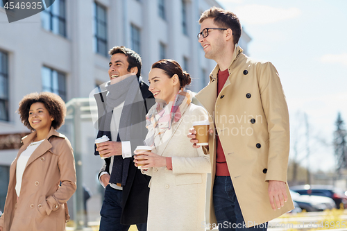 Image of office workers with coffee on city street