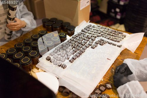 Image of workers at confectionery shop packing candies