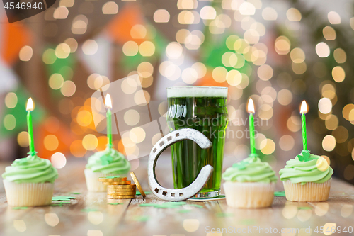 Image of glass of beer, cupcakes, horseshoe and gold coins