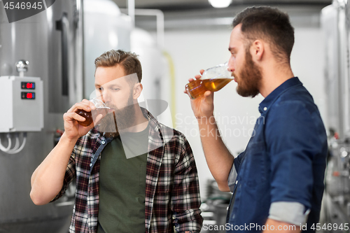 Image of men drinking and testing craft beer at brewery