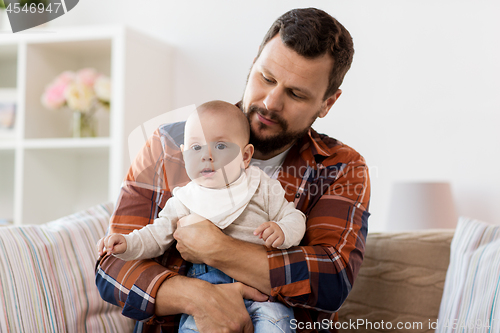 Image of happy father with little baby boy at home