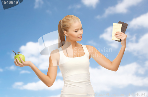 Image of woman choosing between green apple chocolate