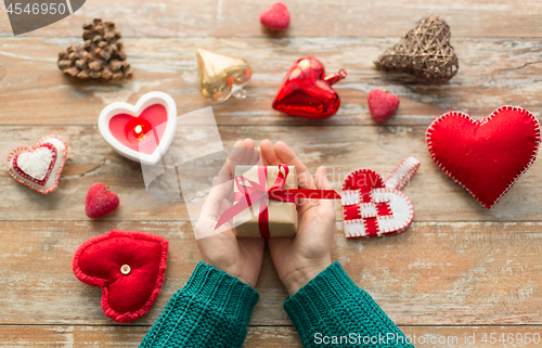 Image of hands holding christmas or valentines day gift