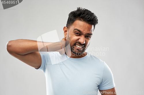 Image of unhealthy indian man suffering from neck pain