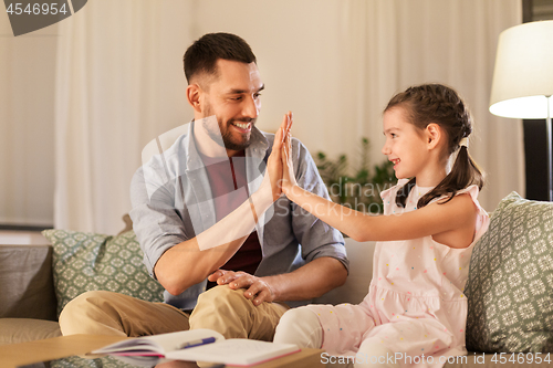 Image of father and daughter doing homework together