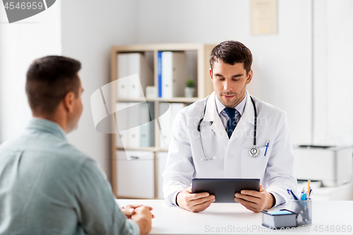 Image of doctor with tablet computer and patient at clinic