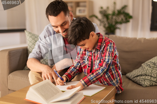 Image of father and son doing homework together