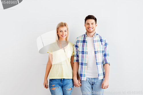 Image of happy couple over white wall background