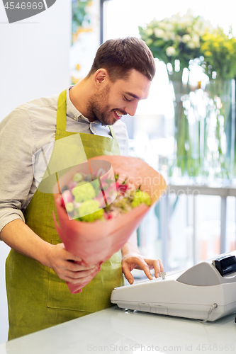 Image of smiling florist man with bunch at flower shop