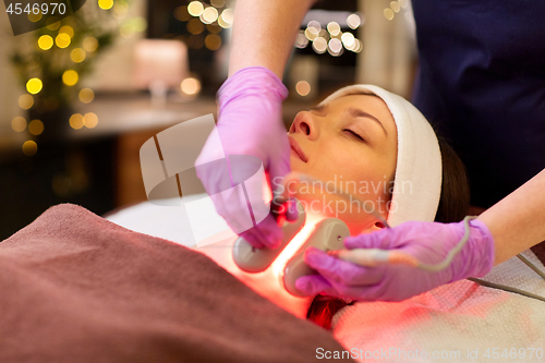 Image of young woman having face microdermabrasion at spa