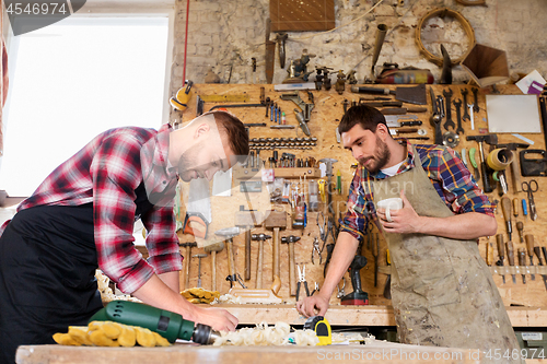 Image of carpenters working and drinking coffee at workshop