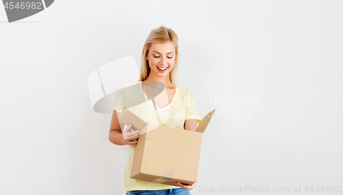 Image of happy woman looking inside cardboard box