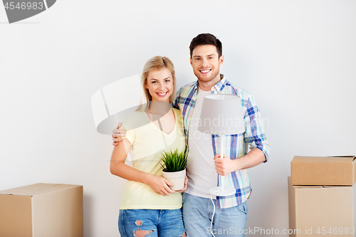 Image of couple with flower and lamp moving to new home