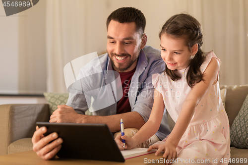 Image of father and daughter doing homework together