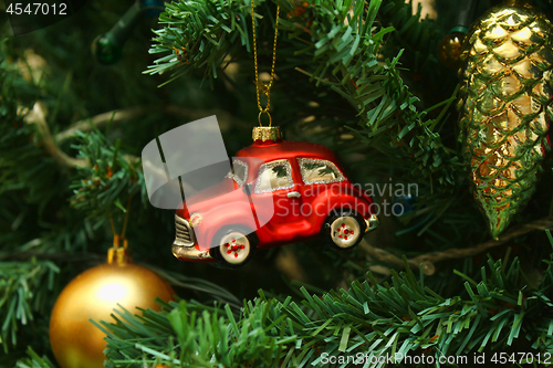 Image of Red car toy, cone and ball on Christmas tree