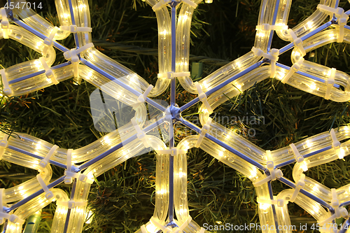 Image of Close-up of bright glowing led christmas snowflake