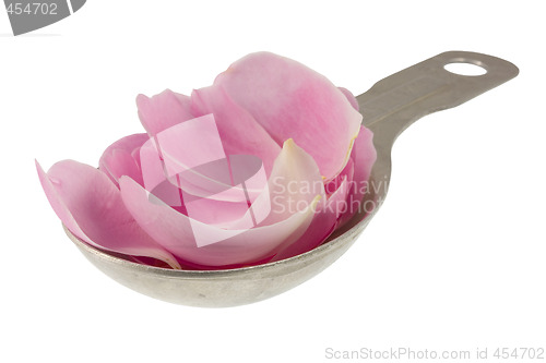 Image of pink rose petals on measuring tablespoon