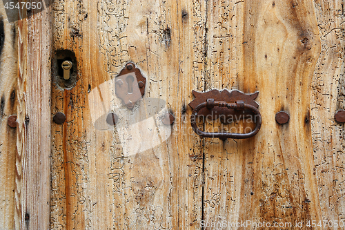 Image of Texture of ancient wooden door with keyholes and handle