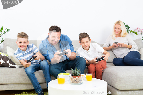 Image of Happy young family playing videogame On TV.