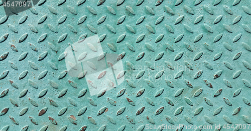 Image of Old metal diamond plate covered with green paint