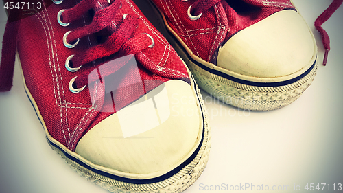 Image of Old crimson sneakers, close-up