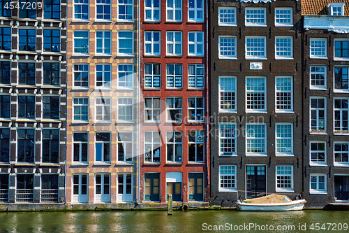 Image of  houses and boat on Amsterdam canal  Damrak with reflection. Ams