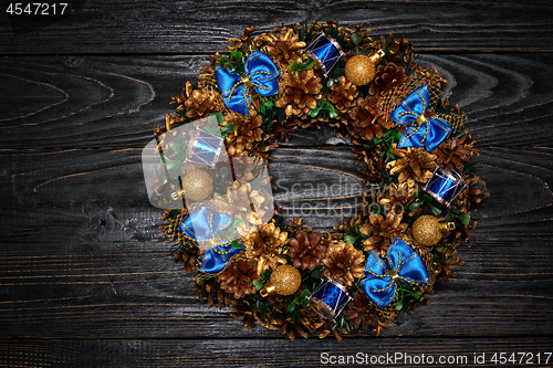 Image of Christmas wreath on wooden background