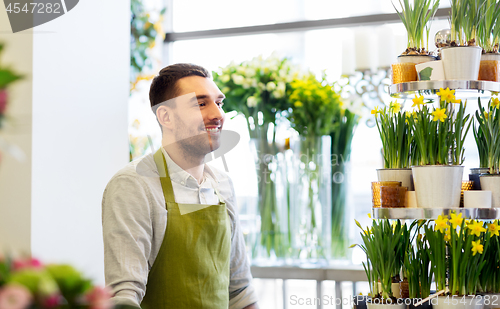 Image of florist man or seller at flower shop counter