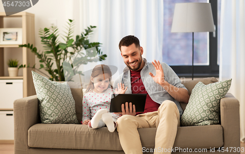 Image of father and daughter having video call on tablet pc