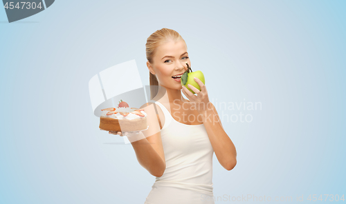 Image of happy woman eating apple instead of cake