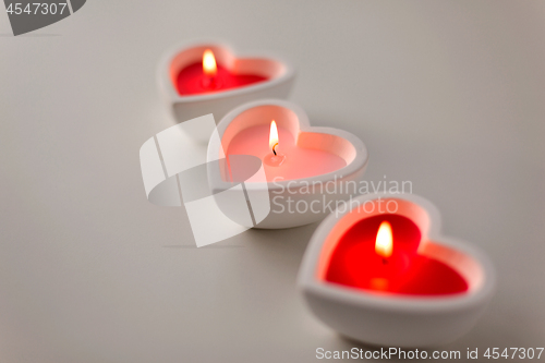 Image of heart shaped candles burning on valentines day