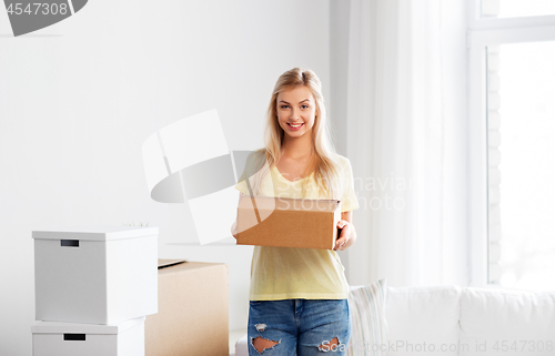 Image of happy woman with boxes moving to new home