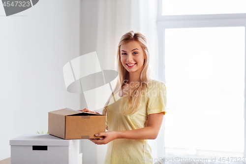 Image of happy woman with boxes moving to new home