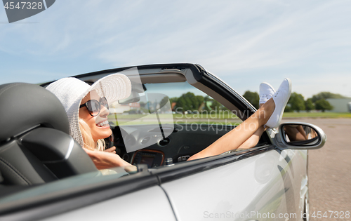 Image of happy woman driving in cabriolet car