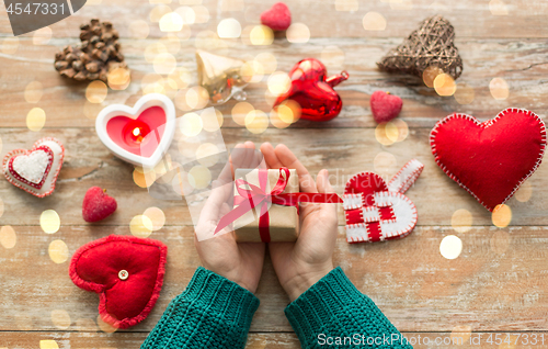 Image of hands holding christmas or valentines day gift