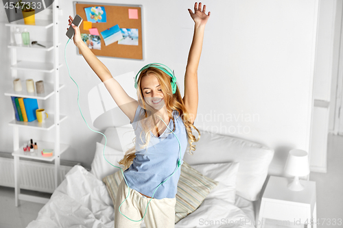 Image of happy woman in headphones having fun at home